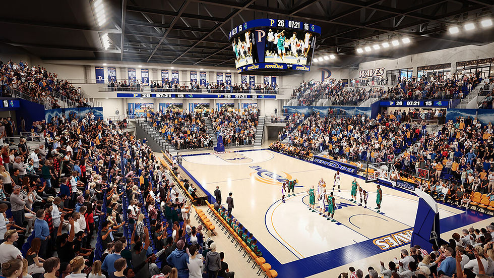 An overview of a University of Vermont basketball game with players on the court and fans in the stands.