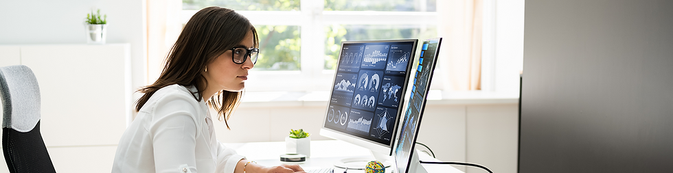 A header image of a woman looking at two computer screens showing graphs