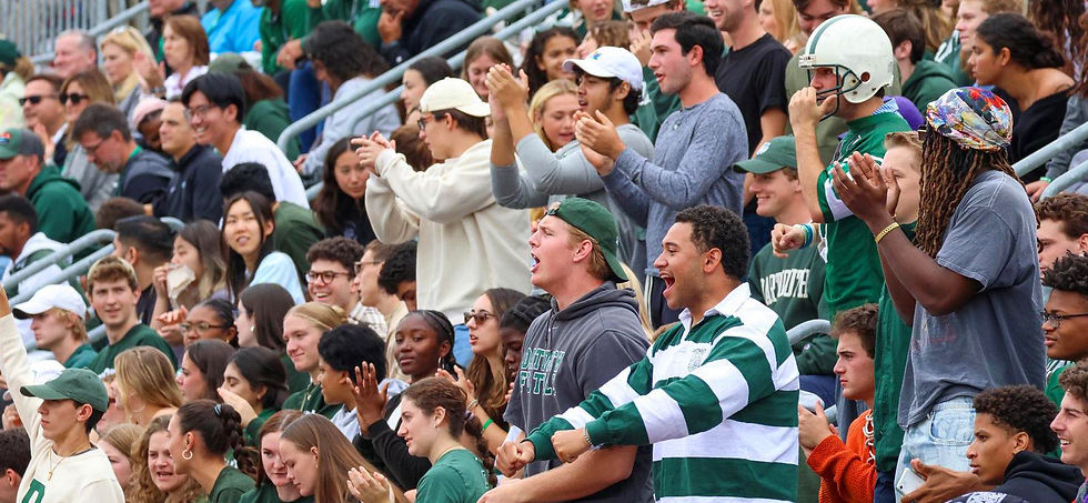 A photo of Darmouth fans cheering in the stands of a football game.