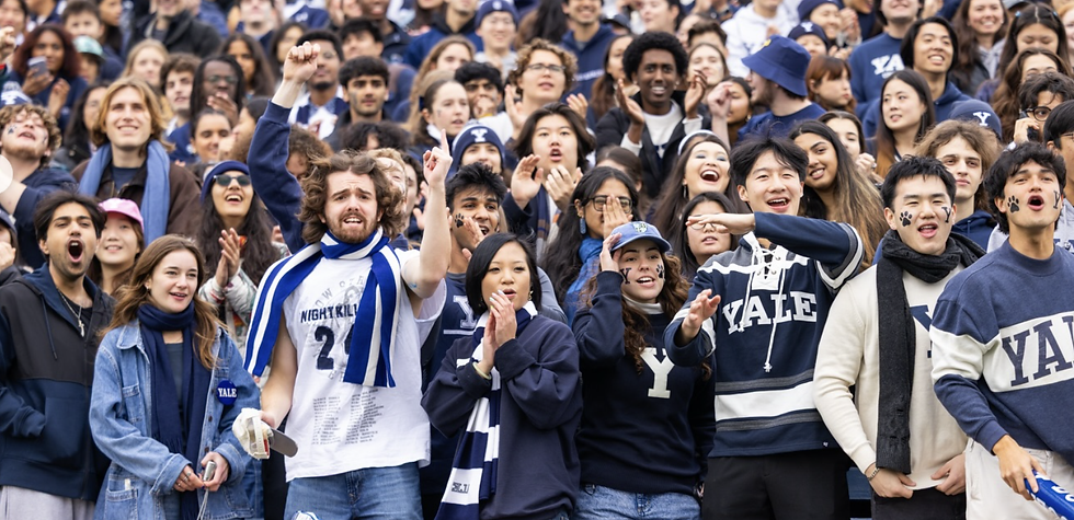 A photo of Yale football fans cheering during a game.